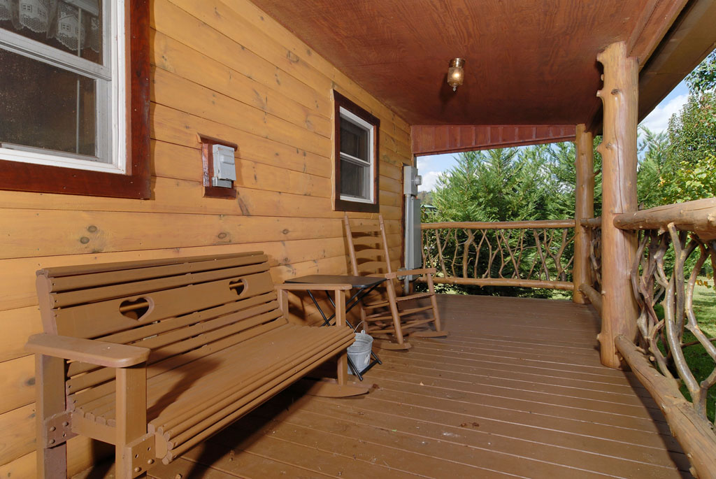 Pigeon Forge Cabin Rental that features a log deck overlooking a flat private area, great for small children